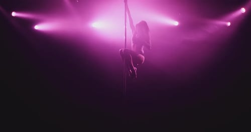 Girl is spinning around a pole