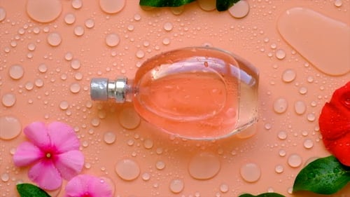 Background with Perfume Water Drops and Flowers