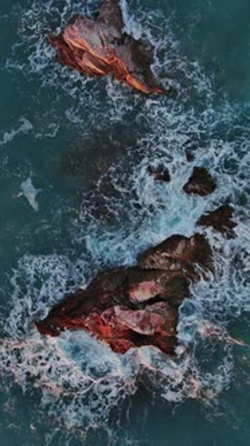 Top View of Waves and Rocks in Sea