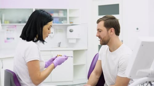 Dentist Discussing Treatment with Patient in Clinic