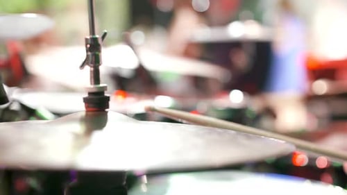 Closeup of Drum Kit Cymbal on Stage with Colorful Concert Lighting
