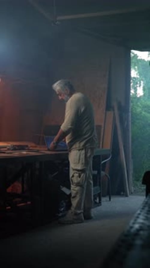Vertical of Aged Craftsman Creates Model of Plane According to Drawings