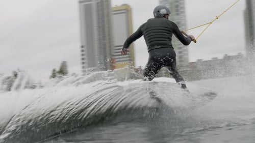 Man Wakeboarding across Lake