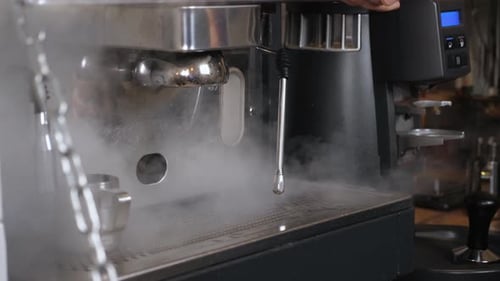 Steam Rises from Espresso Machine in Workplace