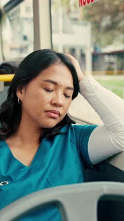Tired, commute or nurse on bus with sleep, exhausted or burnout in city transportation