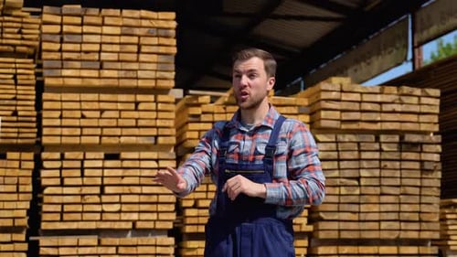 Serious Manager in Uniform Giving Commands to Workers on Lumber Warehouse Bearded Man Gesturing and