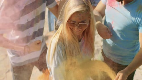 High Angle Shot of a Blonde Girl Throwing Colorful Powder in the Crowd Amidst Hindu Holi Festival C