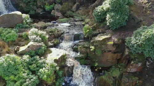 Aerial drone footage of a tall rocky waterfall in the Yorkshire Dales, Pennies. Moorland scene of a