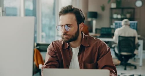 Business, man and reading on laptop in office for research, review article and editing draft