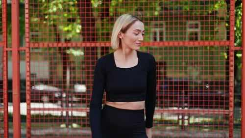 Blonde Woman Dancing for Fitness in Urban Setting