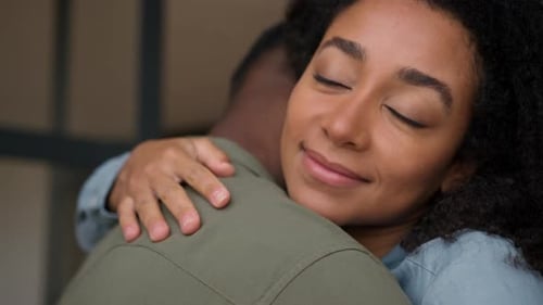 Woman Giving Affectionate Hug to Man Indoors