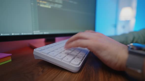 Closeup of the Programmer's Hand at Work Shows How to Type Code on the ...