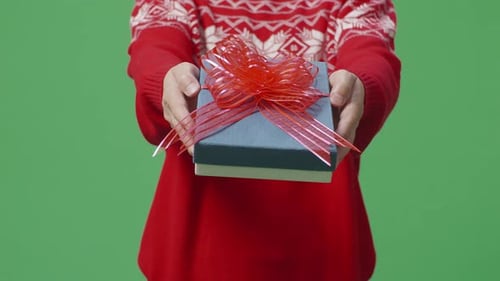 Hands Offering Christmas Gift on Green Screen