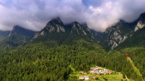 Tops of the mountains are hidden by the dramatic cloudscape.