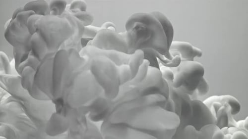 White ink cloud flowing into water abstract background