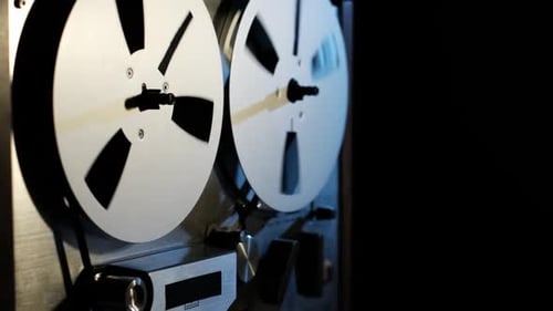 Vintage Reel-to-Reel Tape Recorder in Dark Room