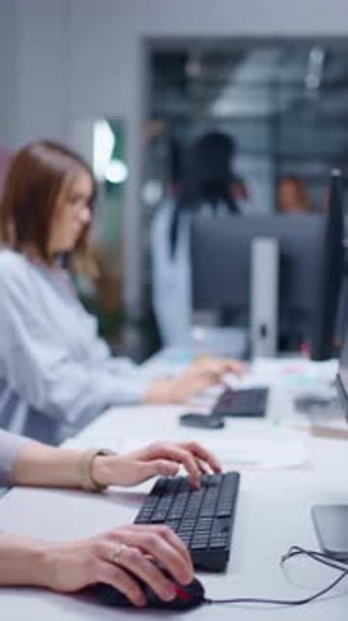 Focused Team Collaborating in a Modern Office Environment Engaged in Work with Computers Showcasing