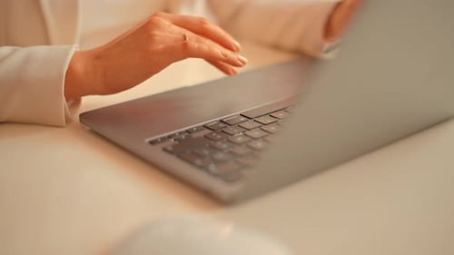 Woman working on mobile phone and notebook at home, stock market