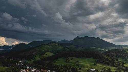 Aerial View Green Mountains and Dramatic Storm Clouds