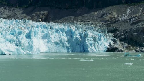Spectacular glacier calving. Ice cubes fell into the water like an explosion.