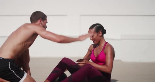Woman and Man Doing Sit Ups Together