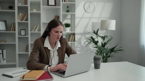 Woman Video Conferencing on Laptop in Home Office