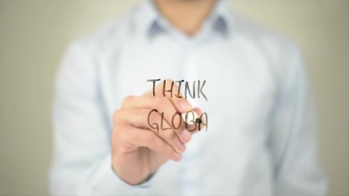 Hand Writes Think Global on Clear Surface