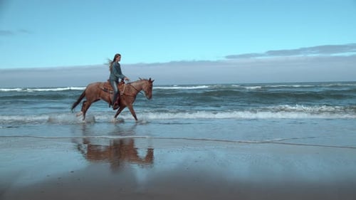Super Shof of Woman Riding Horses at Beach, Oregon,