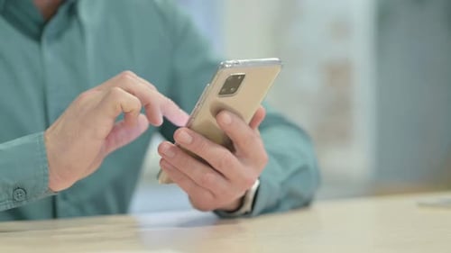 Close up of Hand Browsing Internet on Smartphone