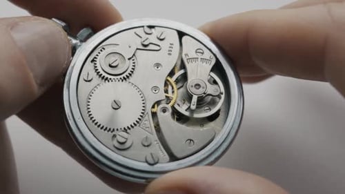 Close Up Of Hands Holding Antique Mechanical Pocket Watch Movement