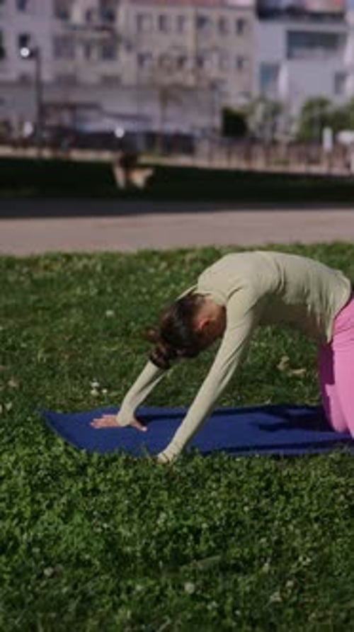 Woman Doing Yoga in Park on Sunny Day