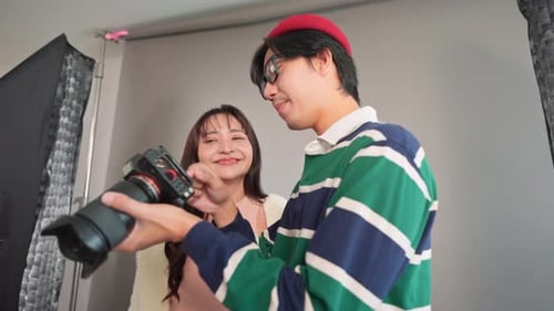 Asian beautiful woman model and cameraman working in photography studio.