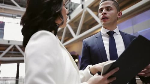 Business colleagues reviewing paperwork during impromptu meeting in the office