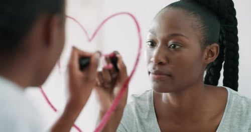 Black woman, mirror and writing heart with lipstick for love, romance or valentines day in bathroom
