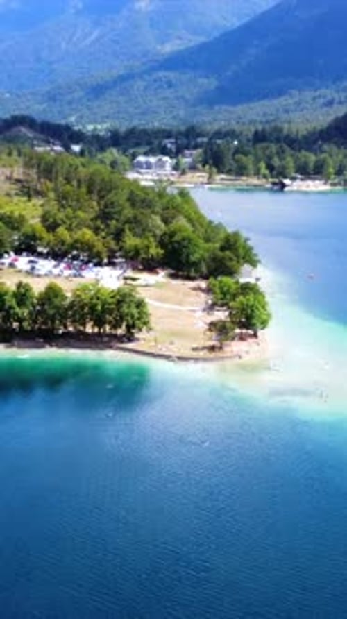 Turquoise Water Surrounding Green Island on Lake Bohinj