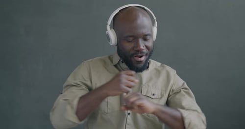 Man Dancing to Music with Headphones On