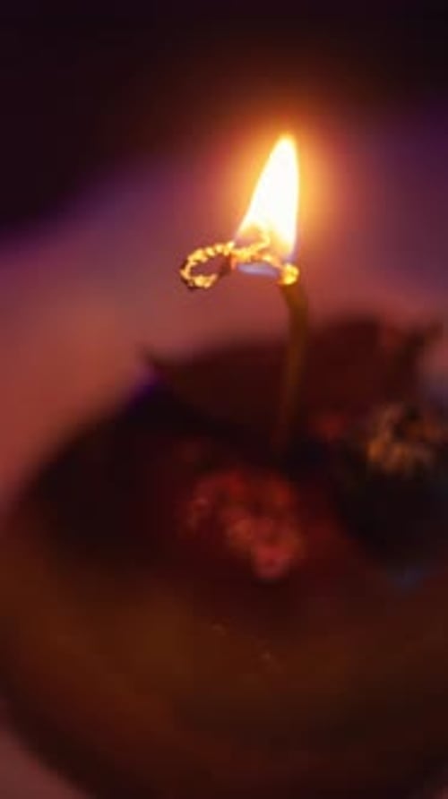 Glowing Candle Flame Lights Dark Interior