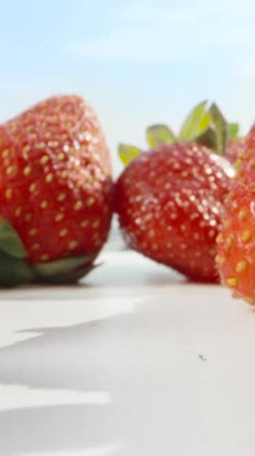 Strawberry against the blue sky, on the table. Dolly slider Vertical. Social Media