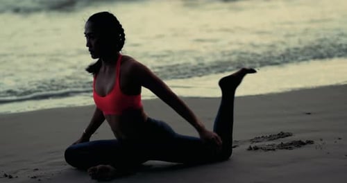 Woman Practicing Yoga on Beach at Sunset