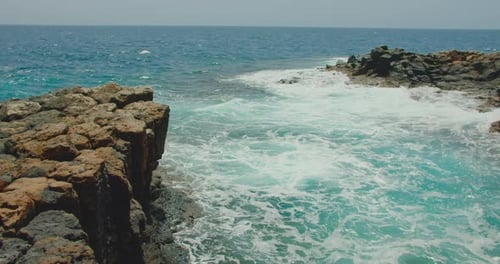 Fuerteventura, Canary Islands. Natural swimming pool. Ocean waves crashing against empty rocky black