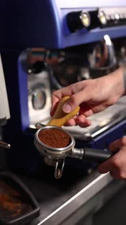 Adult Hand Tamping Coffee Grounds Close Up