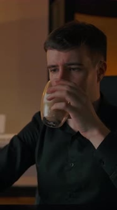 Man Working at Computer While Drinking Coffee