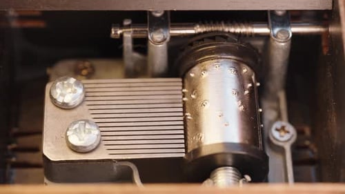 Close-Up of the Mechanism of an Antique Wooden Music Box. Vintage Music Box Mechanism, Metal Pins an