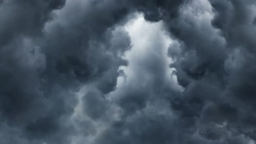 Thick dark clouds of cumulonimbus moved and lightning bolted across the sky