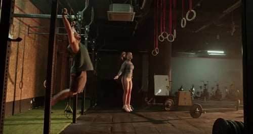 Muscular Man and Woman Training in Gym