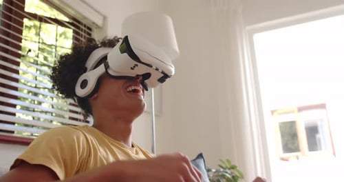 Woman Relaxing on Couch Wearing Virtual Reality Headset