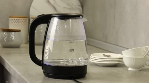 Water Boiling in Clear Electric Kettle on Counter