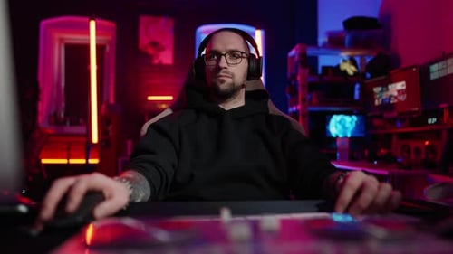 Young Man Gaming with a Computer at Night