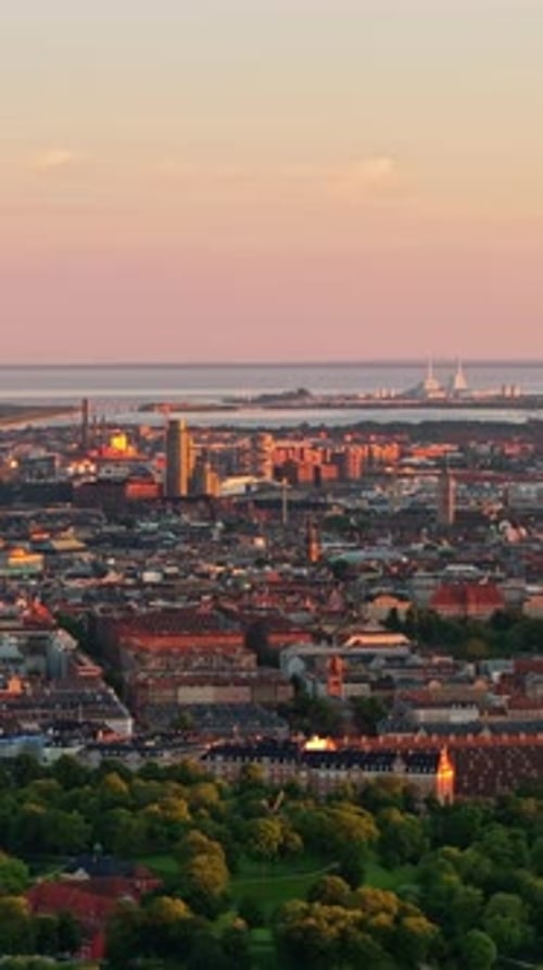 Aerial drone view of the city centre of Copenhagen, Denmark at sunset. Vertical