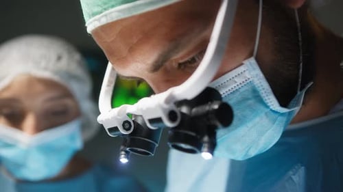 Cardiac Surgeon with Surgical Headlamp Operates at a Heart Stent